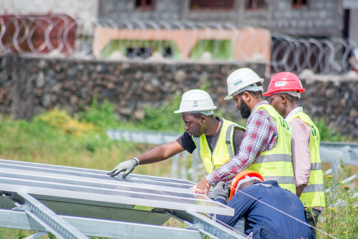 Nuru technicians installing solar panels