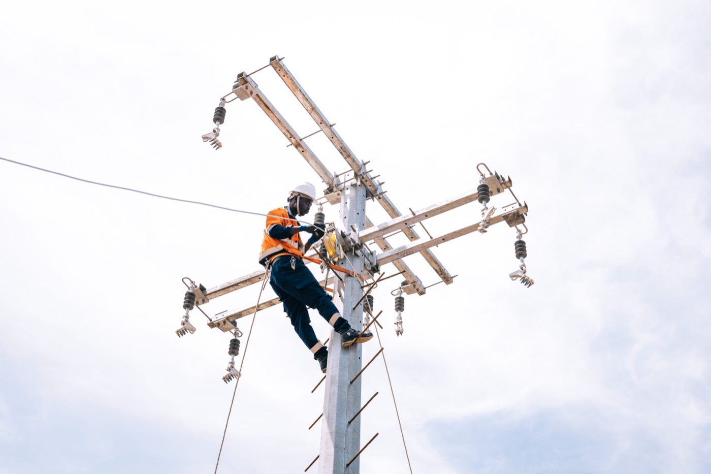 Nuru technician working at the top of a power pole